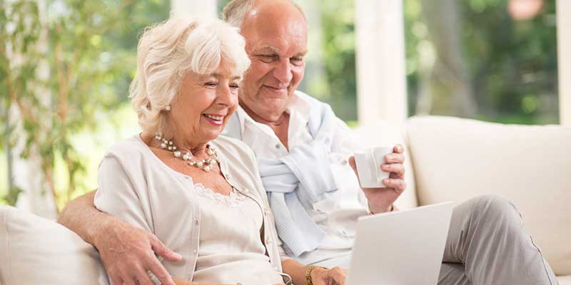 Älteres Paar surft gemeinsam im Internet.